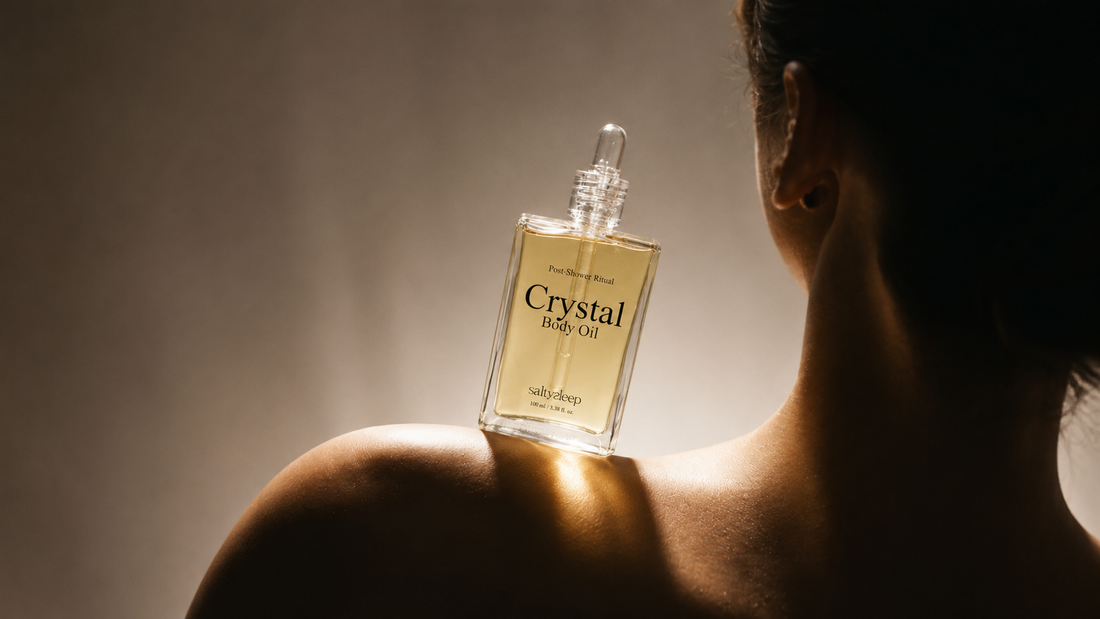 Body oil smoothed along a forearm on slightly damp skin after a shower.