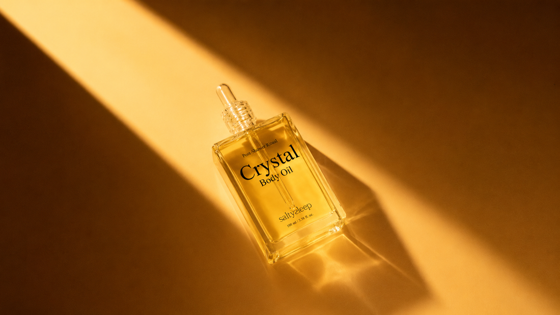 A few drops of dry body oil pooled in an open palm, showing a thin lightweight texture.